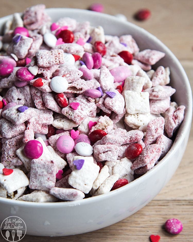 Above shot of valentine\'s day puppy chow in a bowl with powdered sugar and m&m\'s.