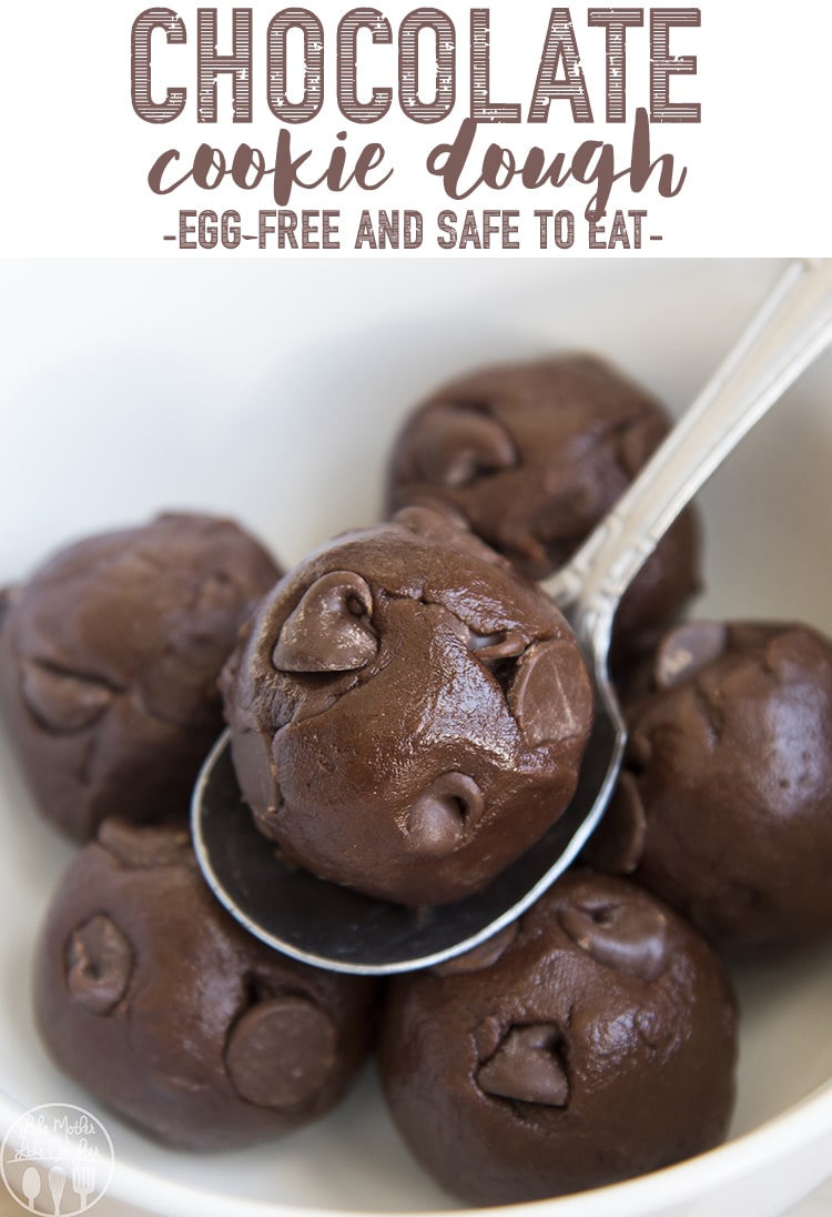 A chocolate cookie dough ball on a spoon.