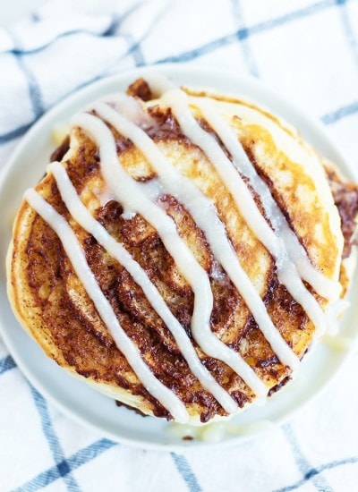 Cinnamon Roll Pancakes with a cinnamon swirl and topped with cream cheese syrup