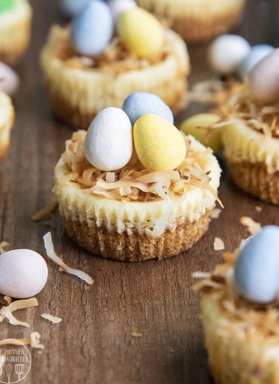 Mini Easter cheesecakes topped with toasted coconut and mini chocolate eggs.