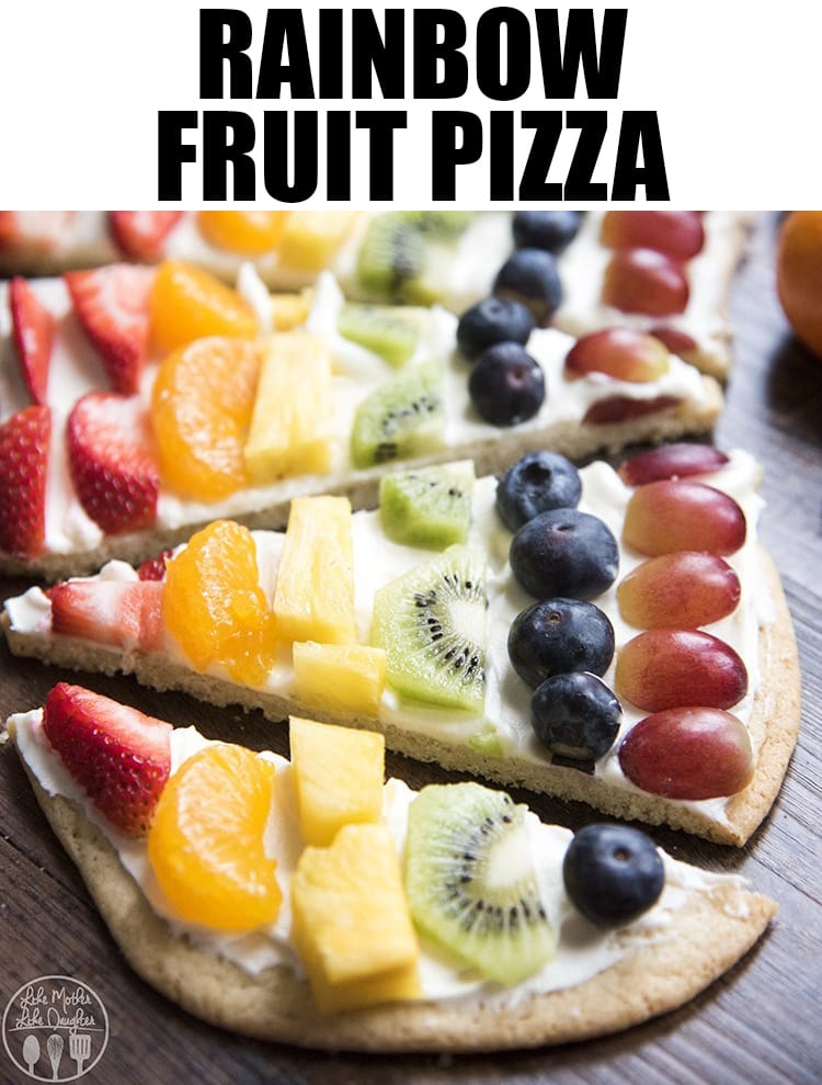 A beautiful rainbow fruit pizza topped with colored fruits and made to look like a rainbow.