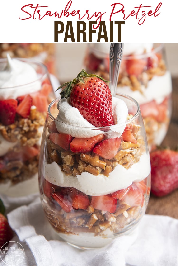 A strawberry, pretzel, and cream cheese parfait in a glass cup.
