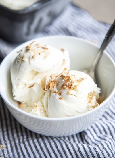 A bowl of coconut ice cream with toasted coconut on top.