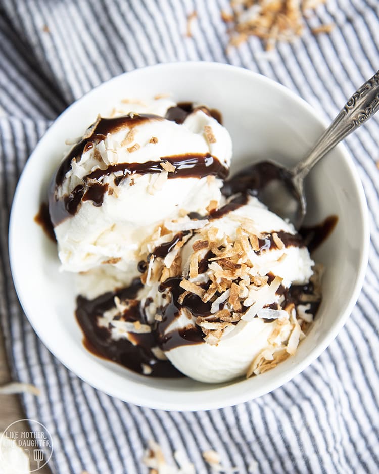 Coconut Ice cream topped with chocolate syrup and toasted coconut flakes