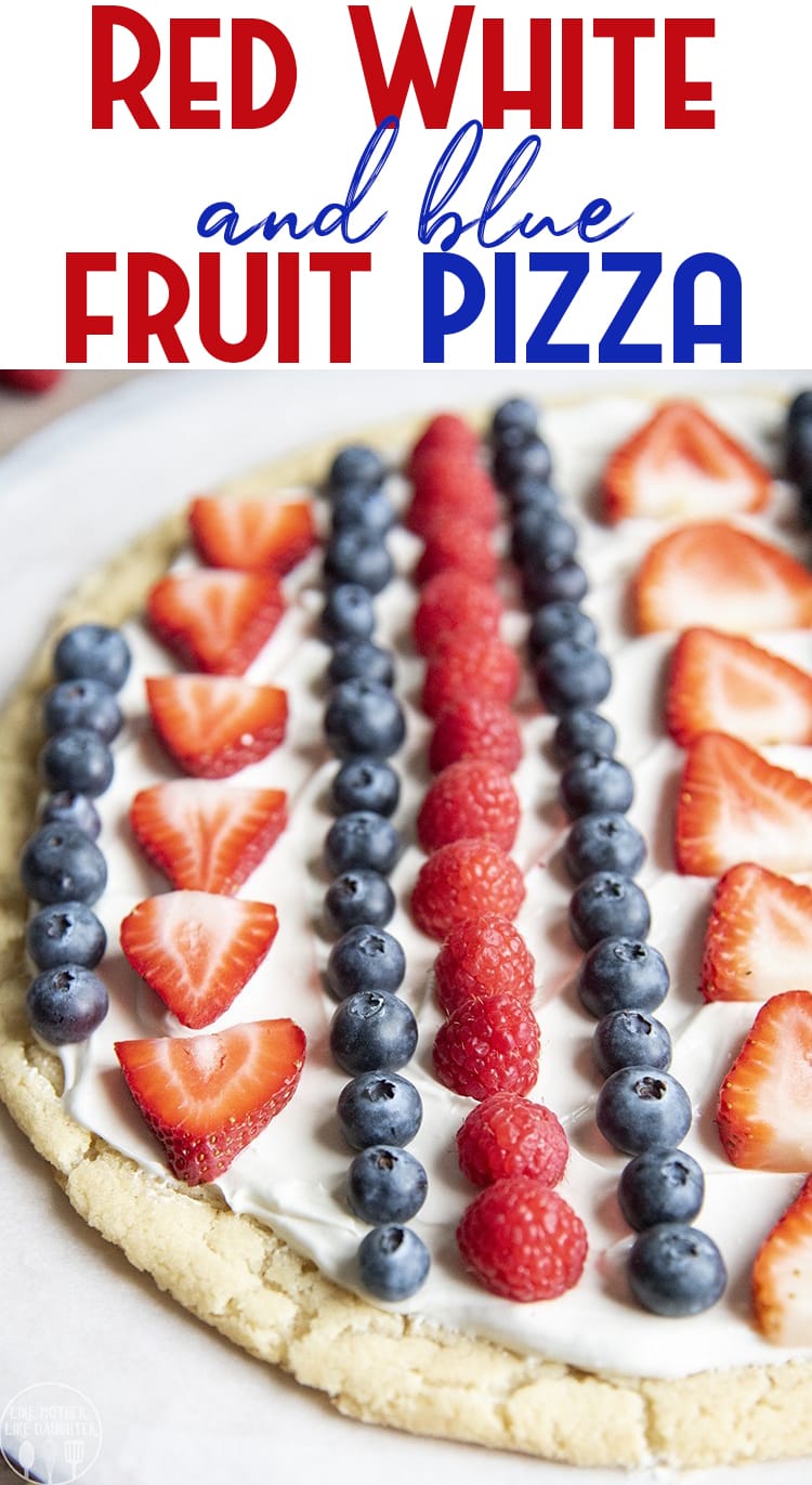A round fruit pizza topped with rows of strawberries, blueberries, and raspberries. 