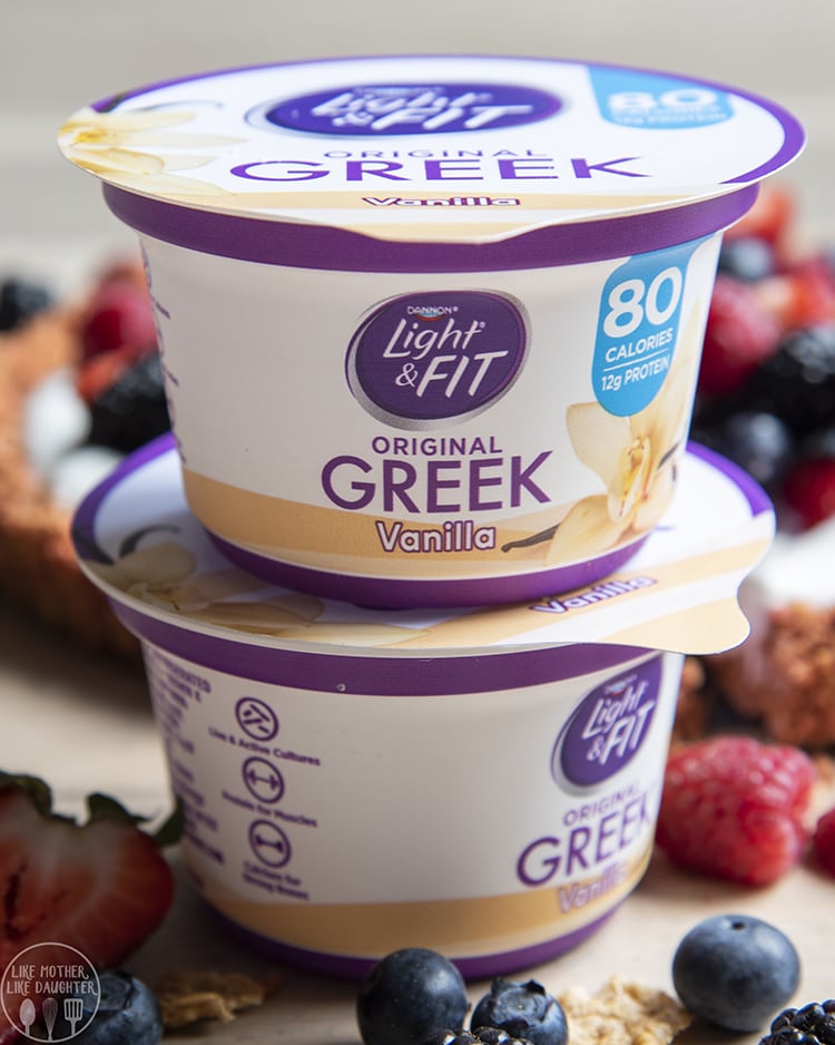 A stack of two vanilla greek yogurt containers. 