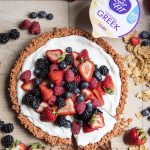 A cereal tart topped with yogurt and fresh fruit.