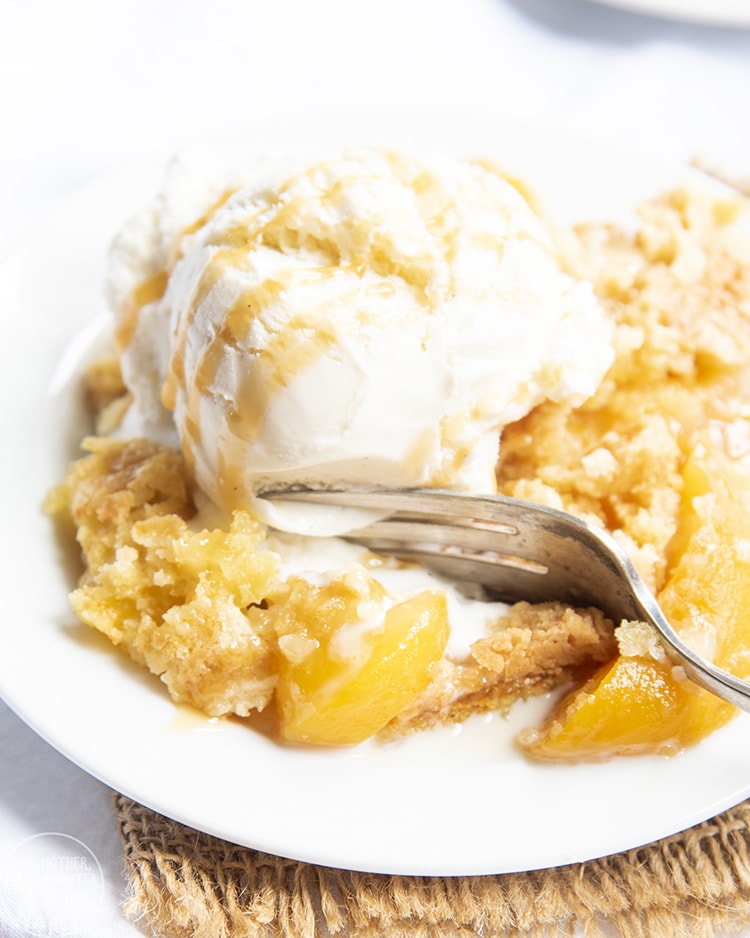 Peach Dump Cake topped with ice cream