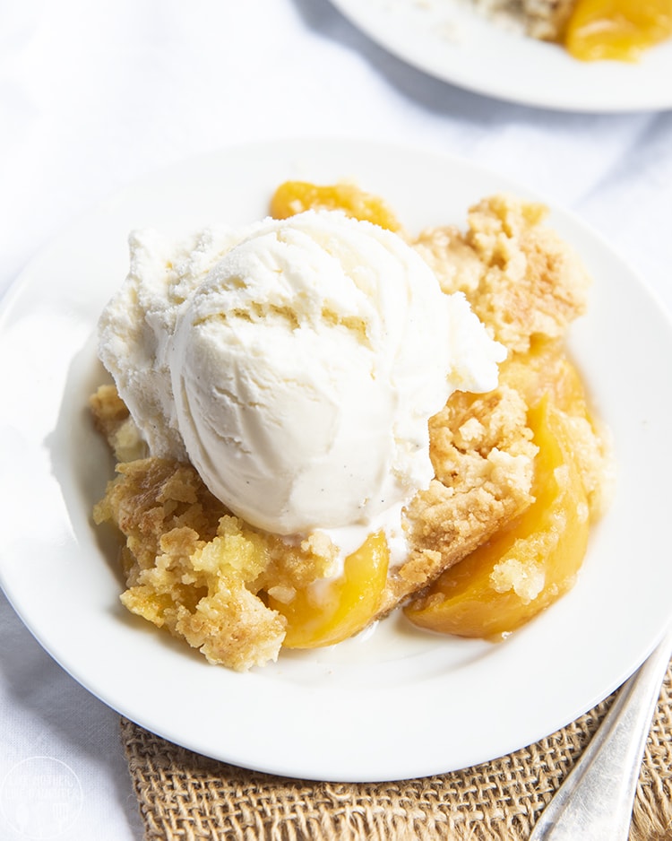 Peach cobbler topped with vanilla ice cream