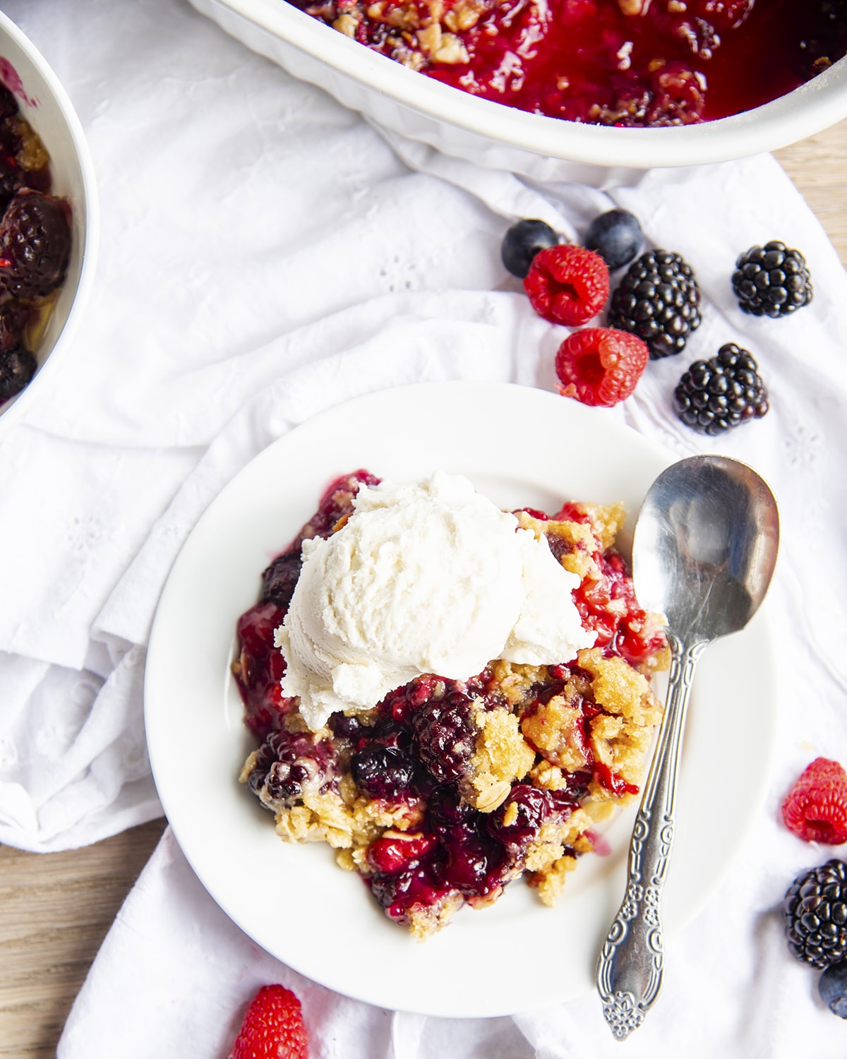An overhead photo of berry crumble with ice cream on top.