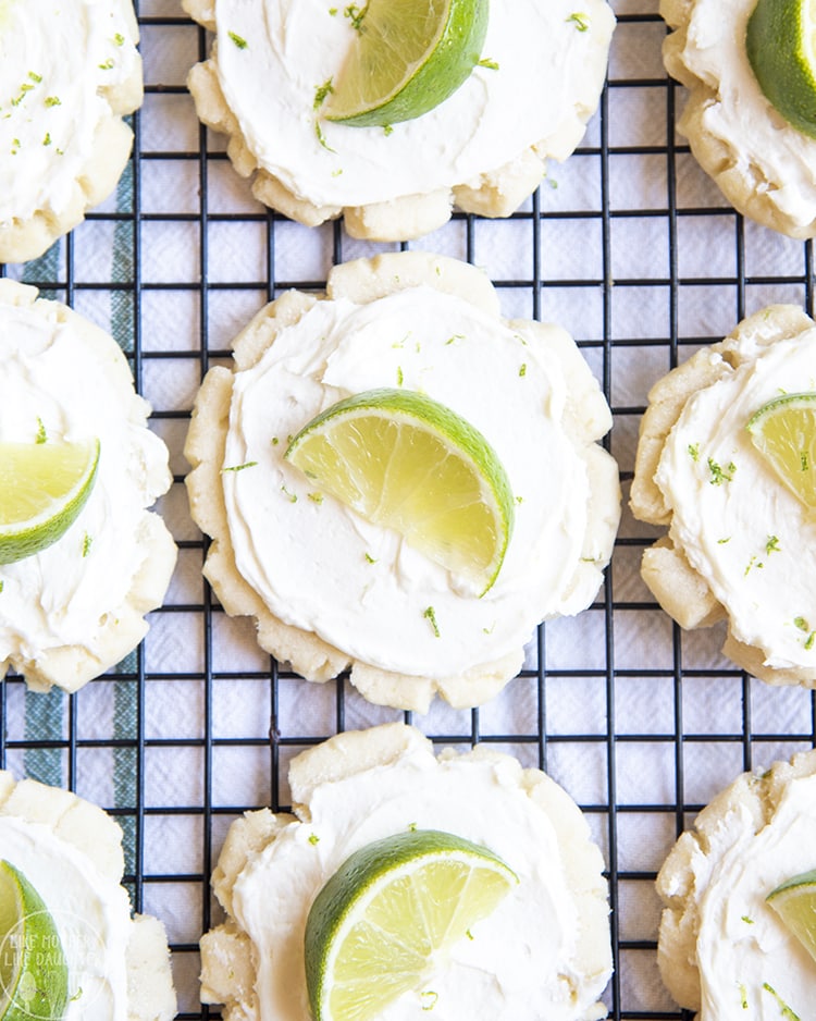 A Coconut Lime Sugar Cookie with coconut frosting and a lime on top
