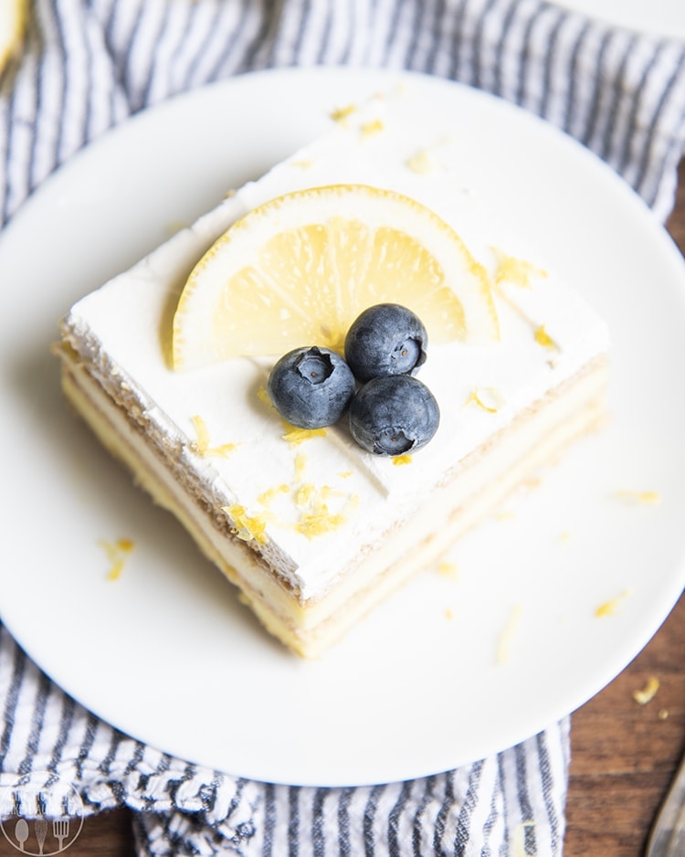 A piece of lemon icebox cake topped with blueberries on a plate.