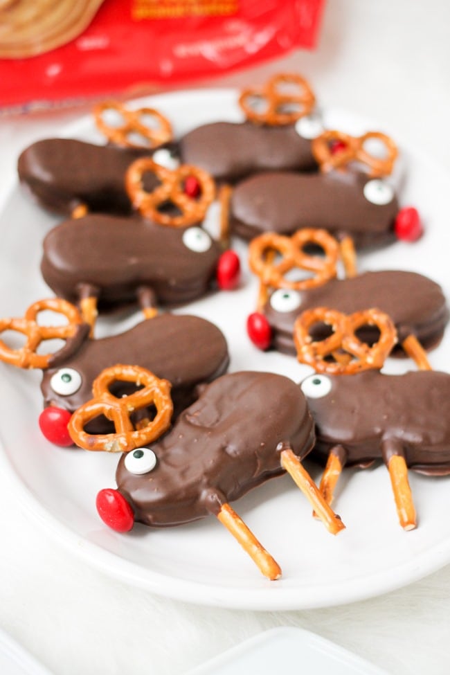 Nutter butter cookies dipped in chocolate and decorated with pretzels to look like reindeer. 