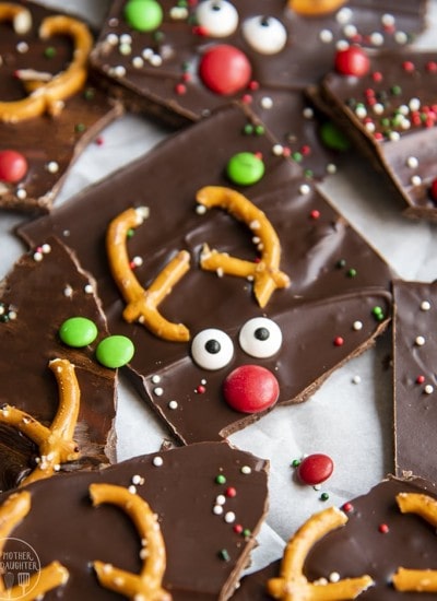 Chocolate bark decorated with pretzels and candies to look like reindeer.