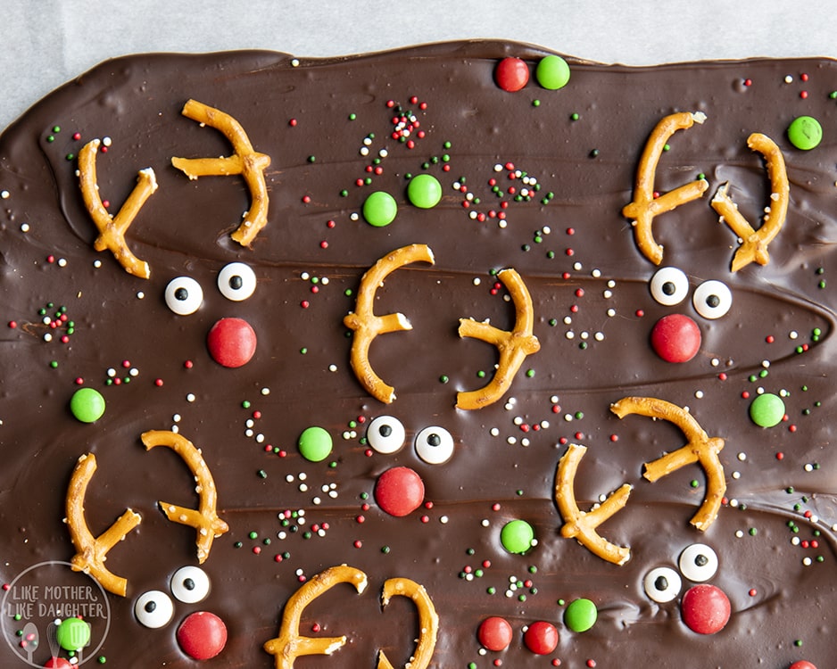 Reindeer Chocolate Bark is topped with m&ms and christmas sprinkles and reindeer faces