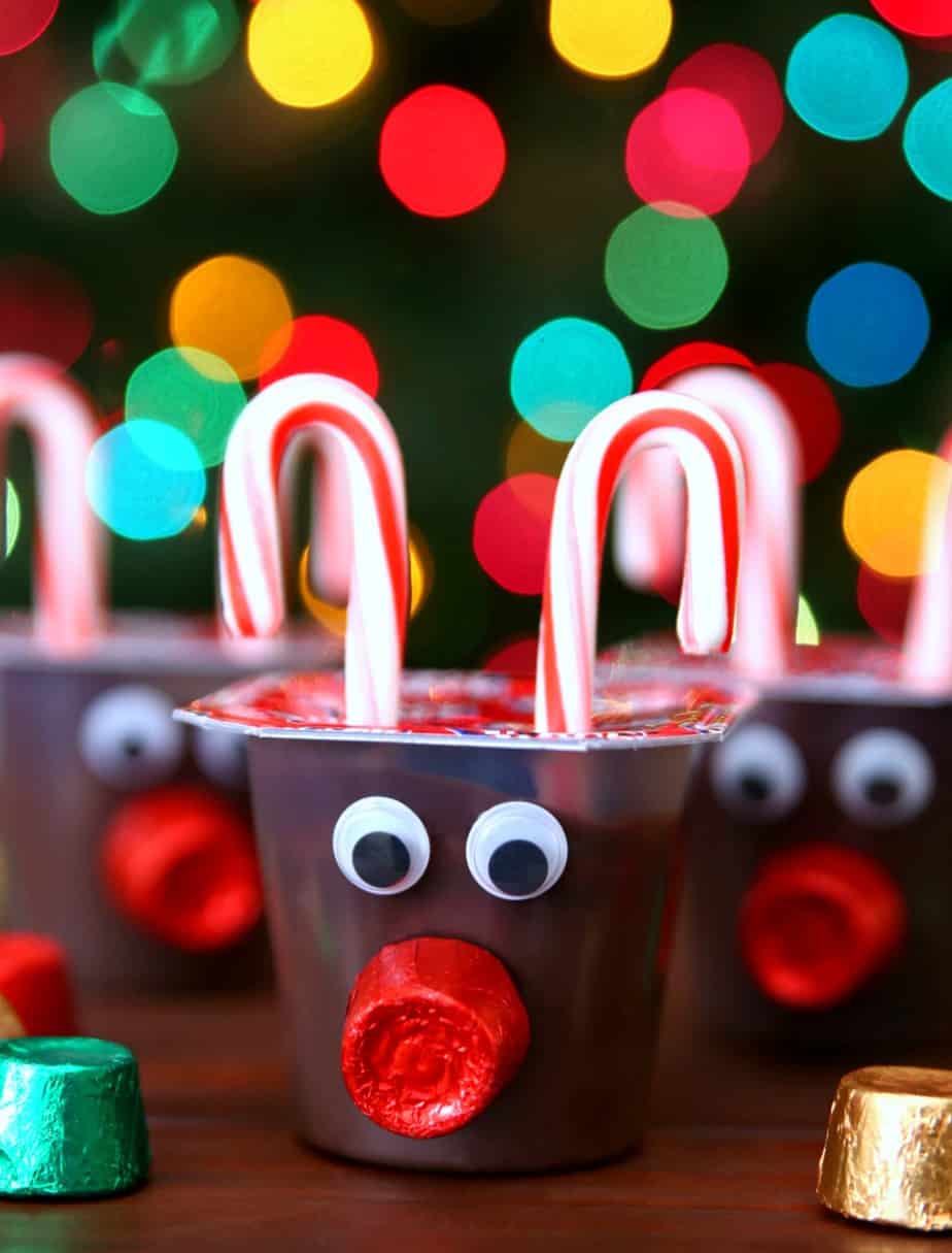 Pudding cups decorated with candy canes, and googly eyes to look like reindeer.