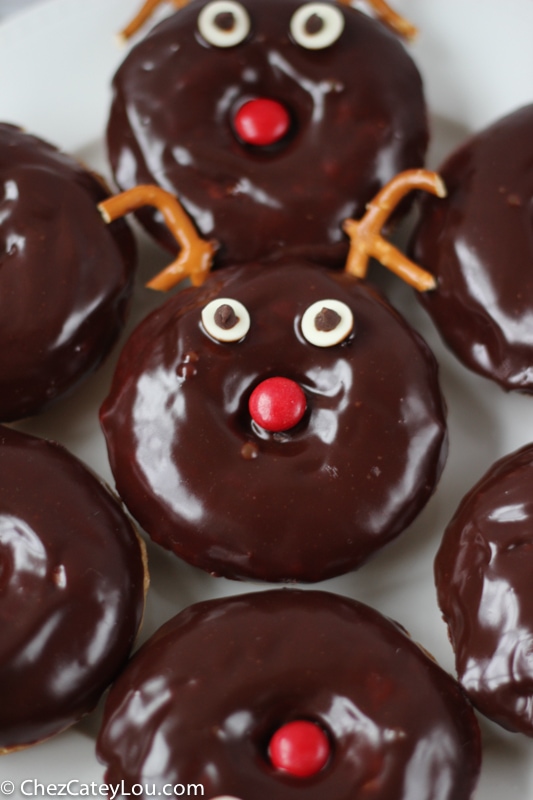 A chocolate donut decorated to look like a reindeer. 