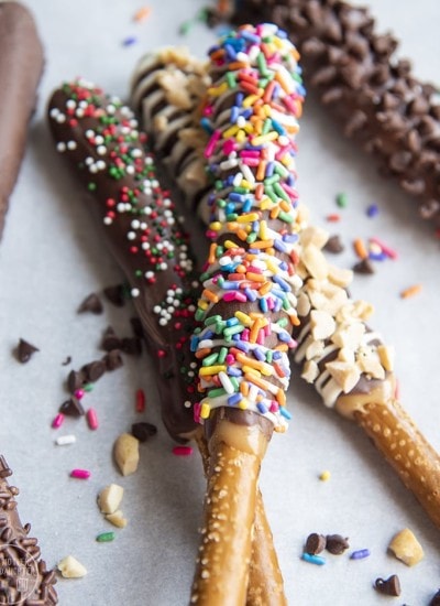 Chocolate and caramel covered pretzel rods topped with sprinkles.
