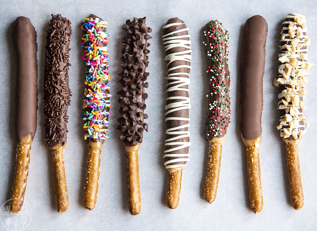 Pretzel Rods coated in caramel and chocolate and sprinkles.