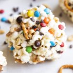 A popcorn ball loaded with pretzels, mini m&ms, and mini chocolate chips.