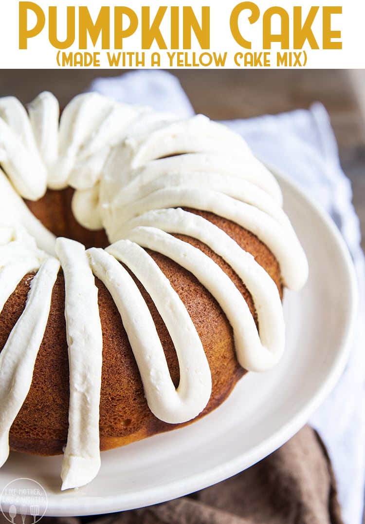A bundt cake topped with cream cheese frosting on a cake stand.