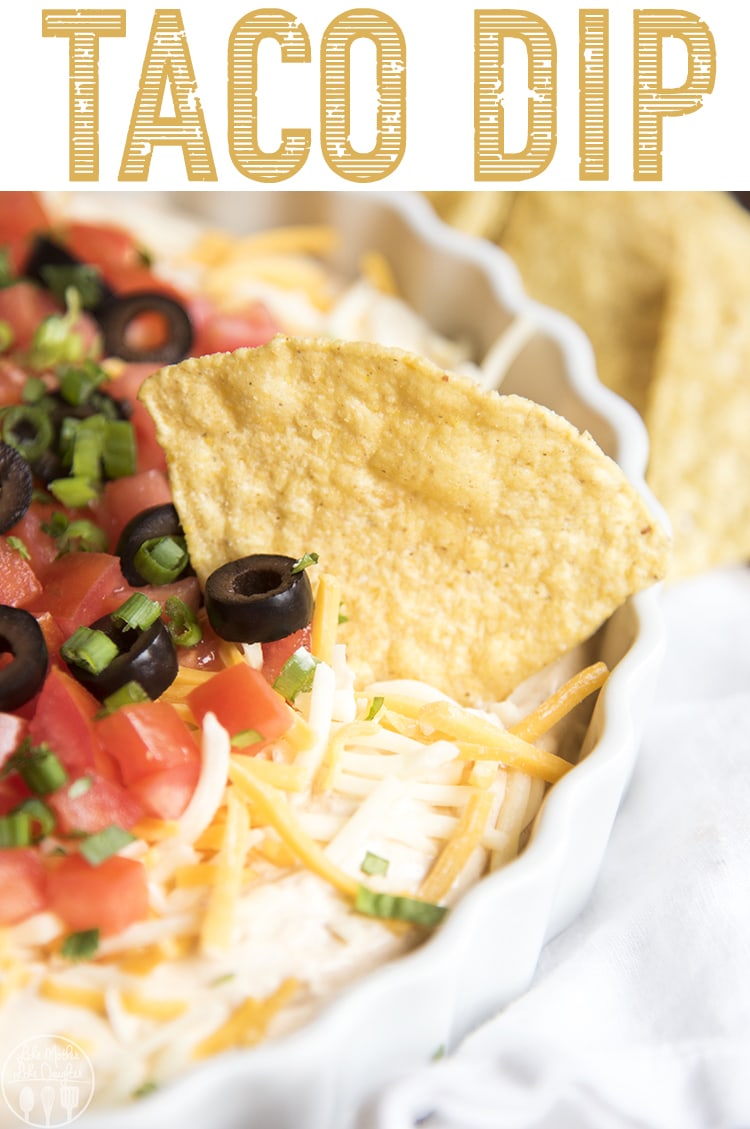 Taco dip in a platter with a chip on top.