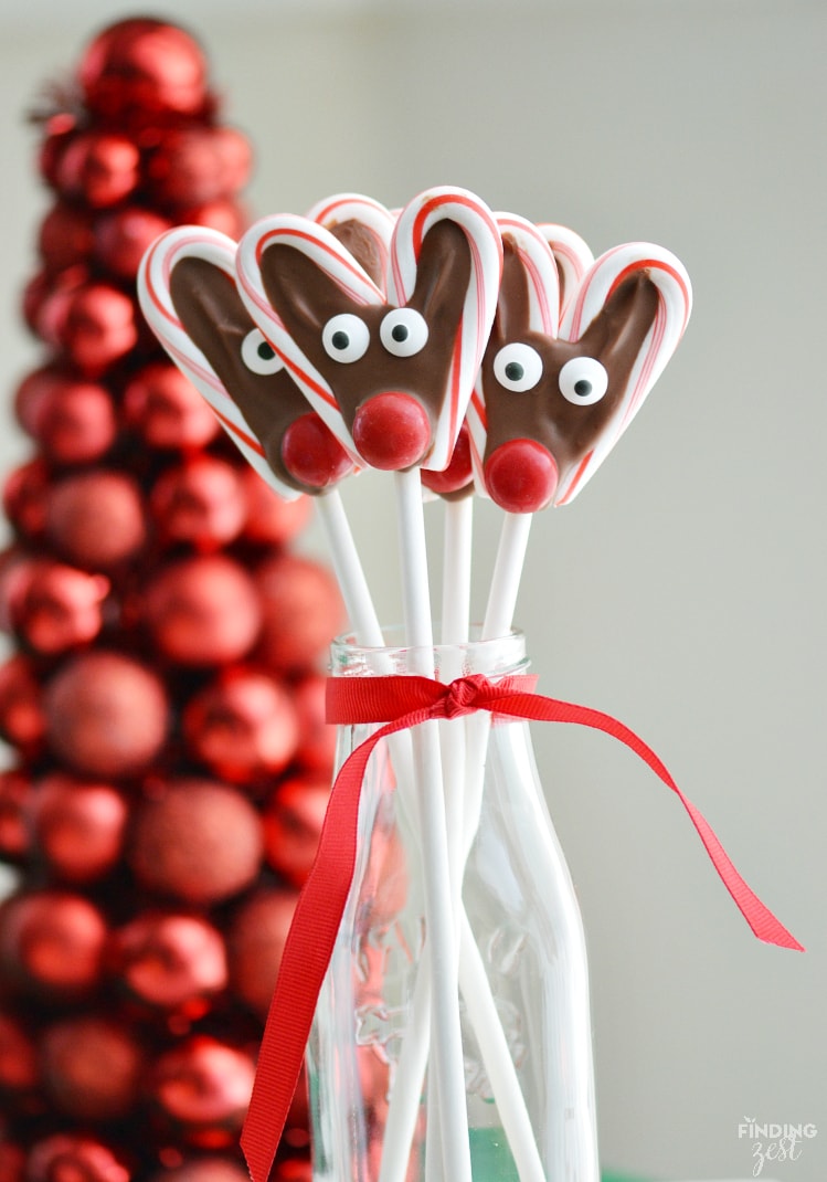 Two candy canes with chocolate in the middle, and decorated to look like reindeer. 