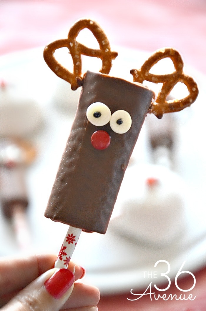 A chocolate hostess dessert on a stick, decorated with pretzel antlers. 