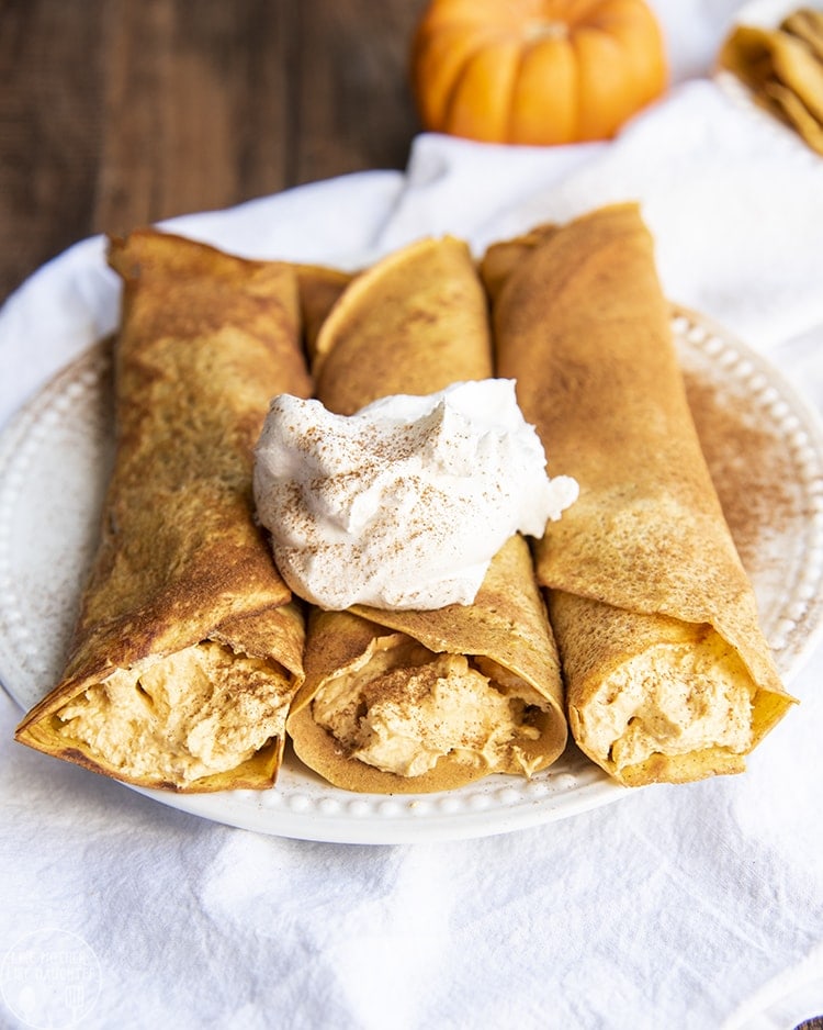 Pumpkin crepes full of a pumpkin filling, and topped with whipped cream.