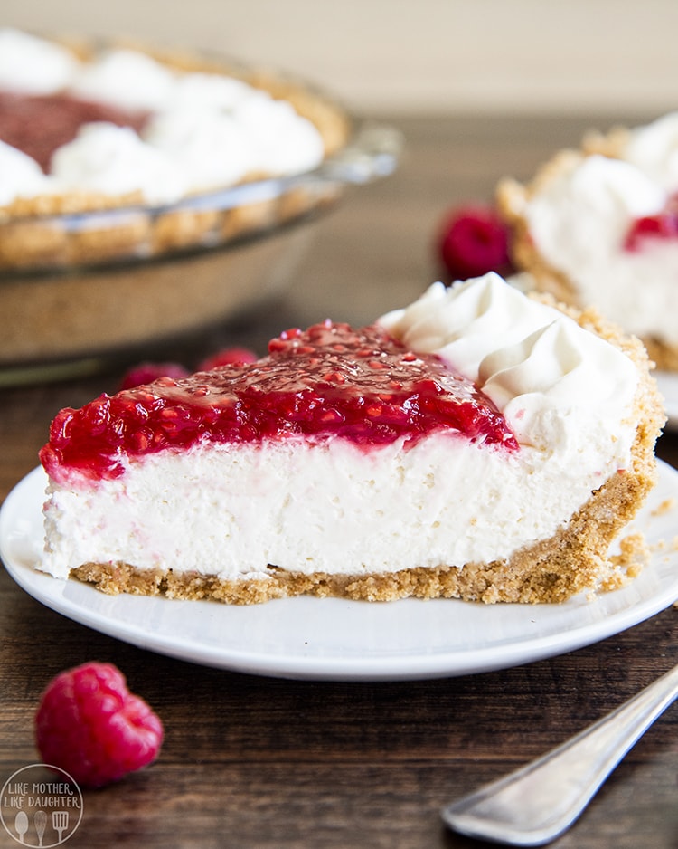 Raspberry Cream Pie with a graham cracker crust, no bake cheesecake filling, topped with fresh raspberry sauce and whipped cream