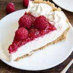 A slice of raspberry cream pie on a plate.
