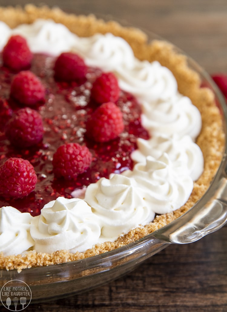 Raspberry Cream Cheese Pie topped with raspberries and whipped cream