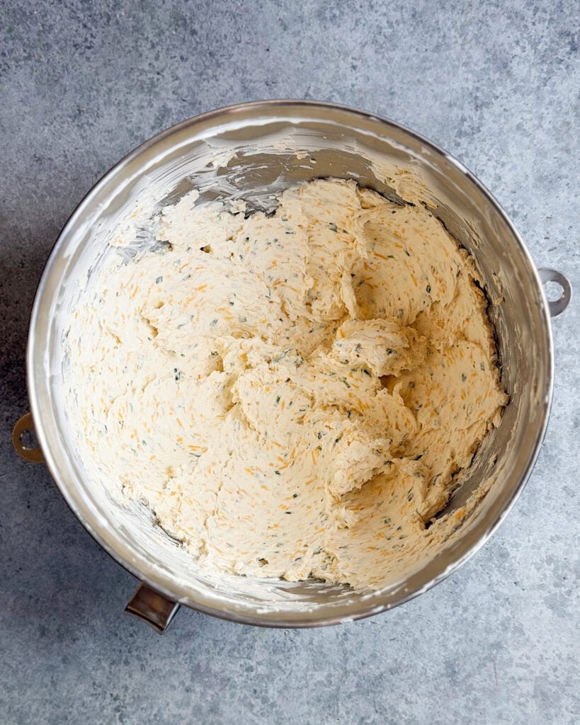 Cheeseball mixture in a big metal bowl.