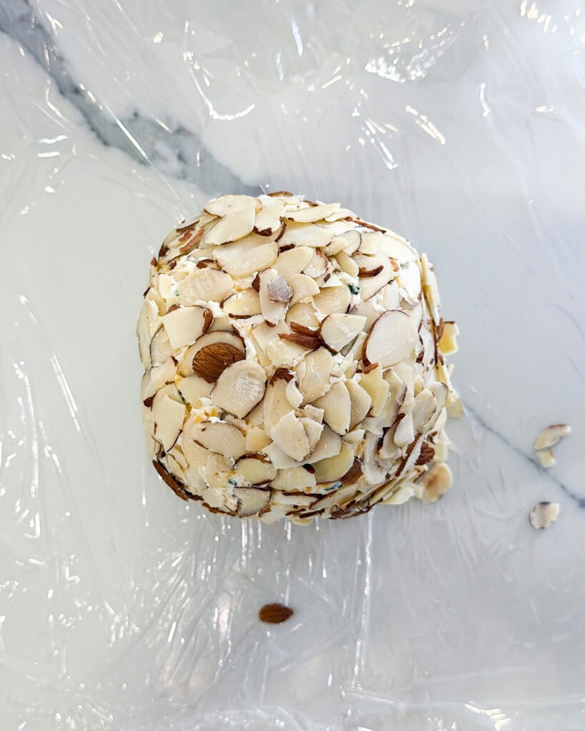 A cheese ball covered in sliced almonds.