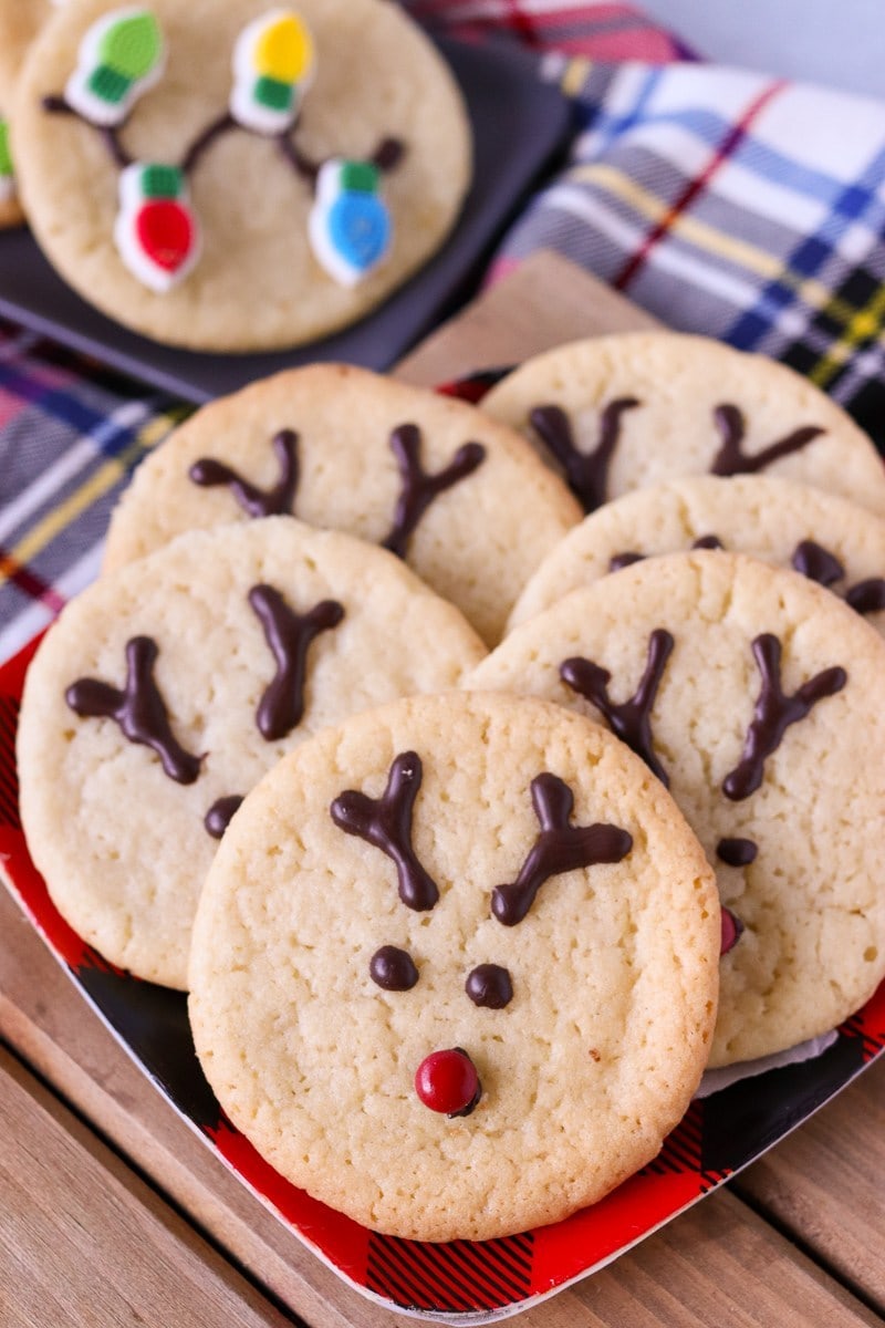 Round sugar cookies decorated with chocolate to look like reindeers. 
