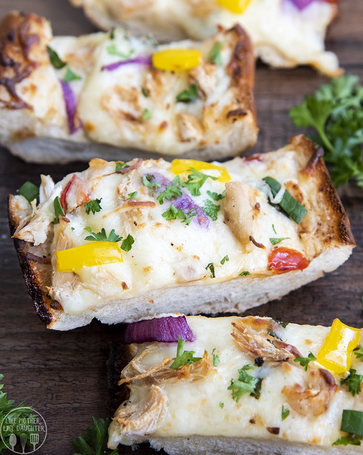 Chicken Alfredo French Bread Pizza with Red Onion and Bell Peppers on top