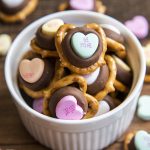 Above image of conversation heart chocolate pretzels in a white bowl.