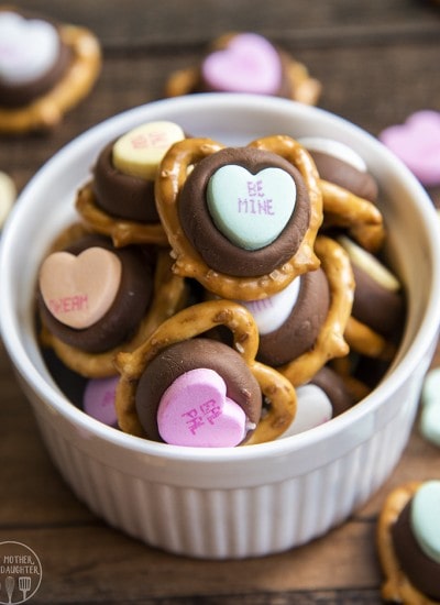 Above image of conversation heart chocolate pretzels in a white bowl.