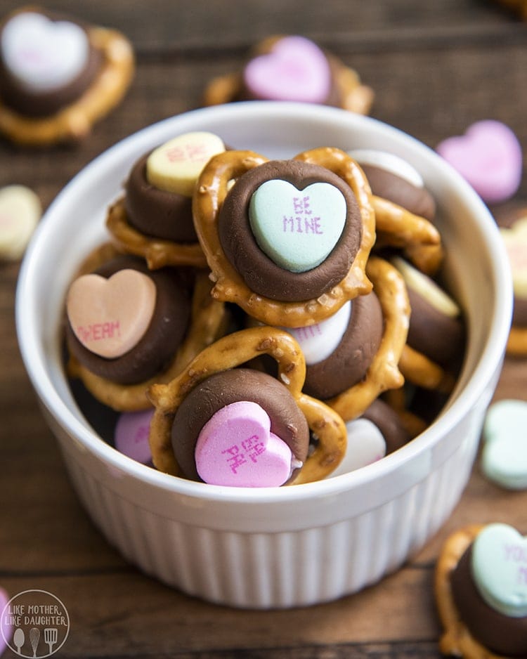 Above image of conversation heart chocolate pretzels in a white bowl.