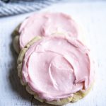 Close up image of copycat swig sugar cookies with pink frosting on top.