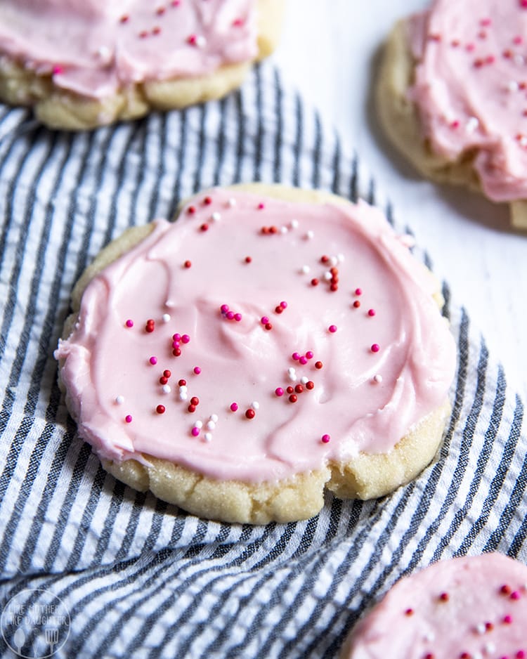 Bakery Style Sugar Cookies with a thick soft buttery cookie, topped with smooth pink frosting