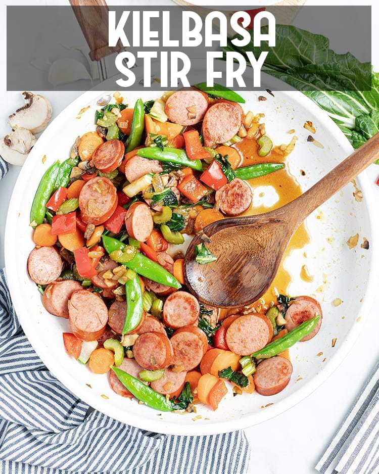 Above image of polska kielbasa stir fry in a white bowl with a wooden spoon with title card.