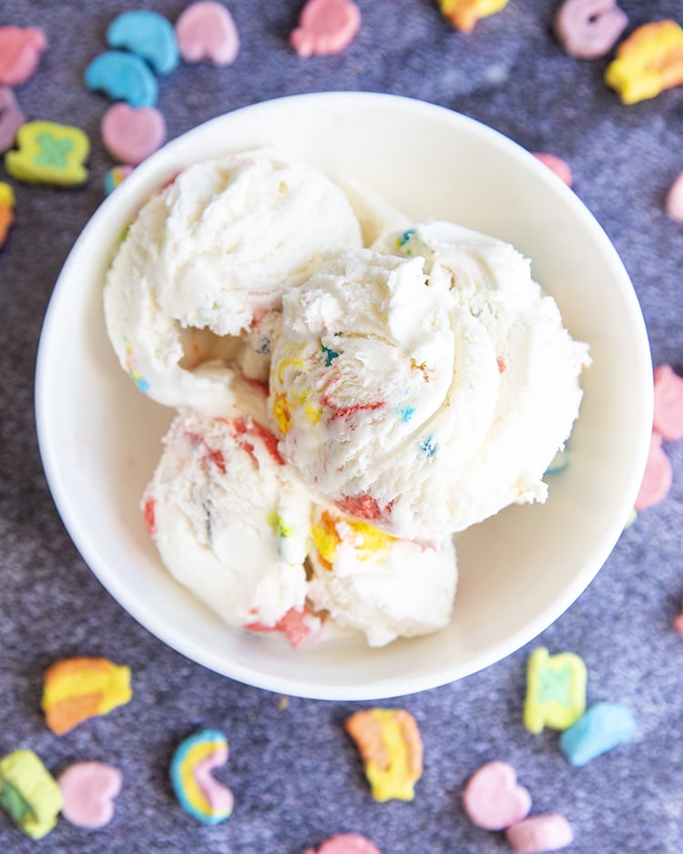 Above image of lucky charms cereal milk ice cream scoops in a white bowl.