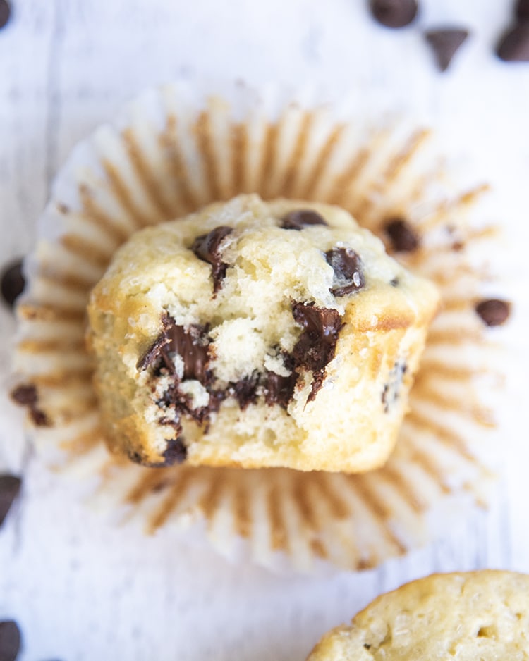 A close-up shot of chocolate chip muffins with a bite out of it.