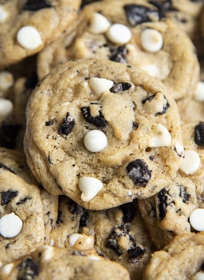 Close-up image of cookies and cream cookies with cookie pieces and white chocolate chips.