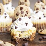 Mini Chocolate Chip Cookie Cheesecakes with whipped cream, chocolate chips, and a chocolate chip cookie on top
