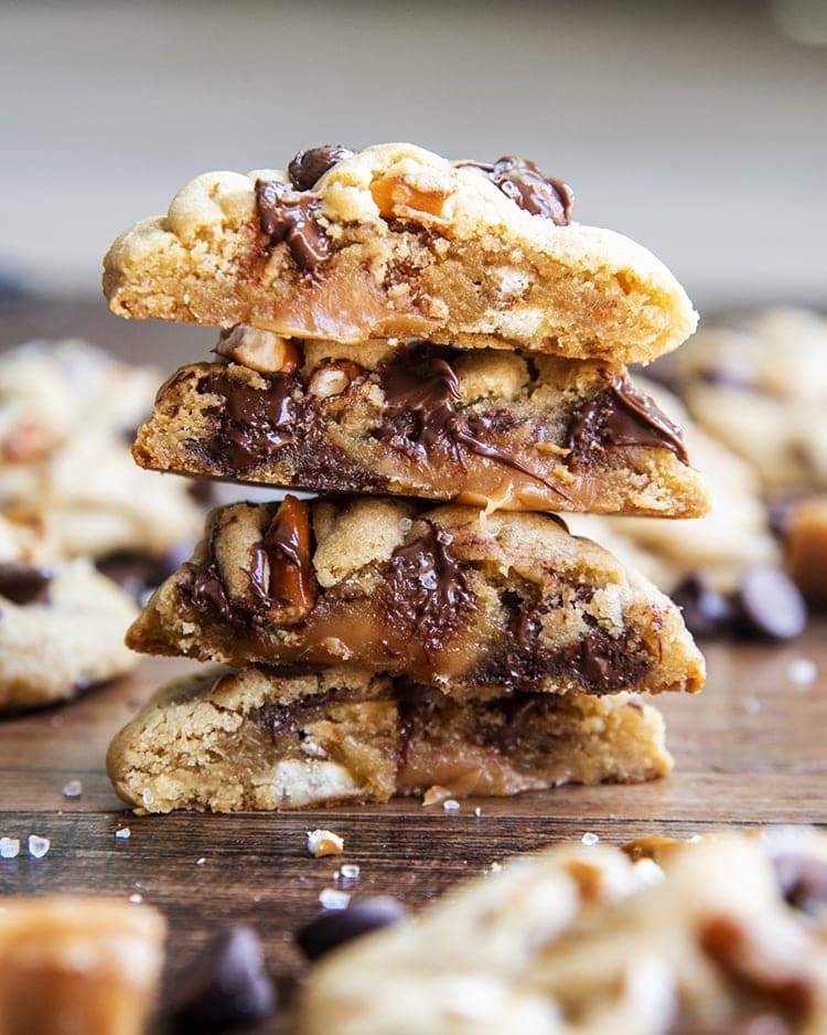 A stack of caramel pretzel chocolate chip cookies showing the middle of the cookie