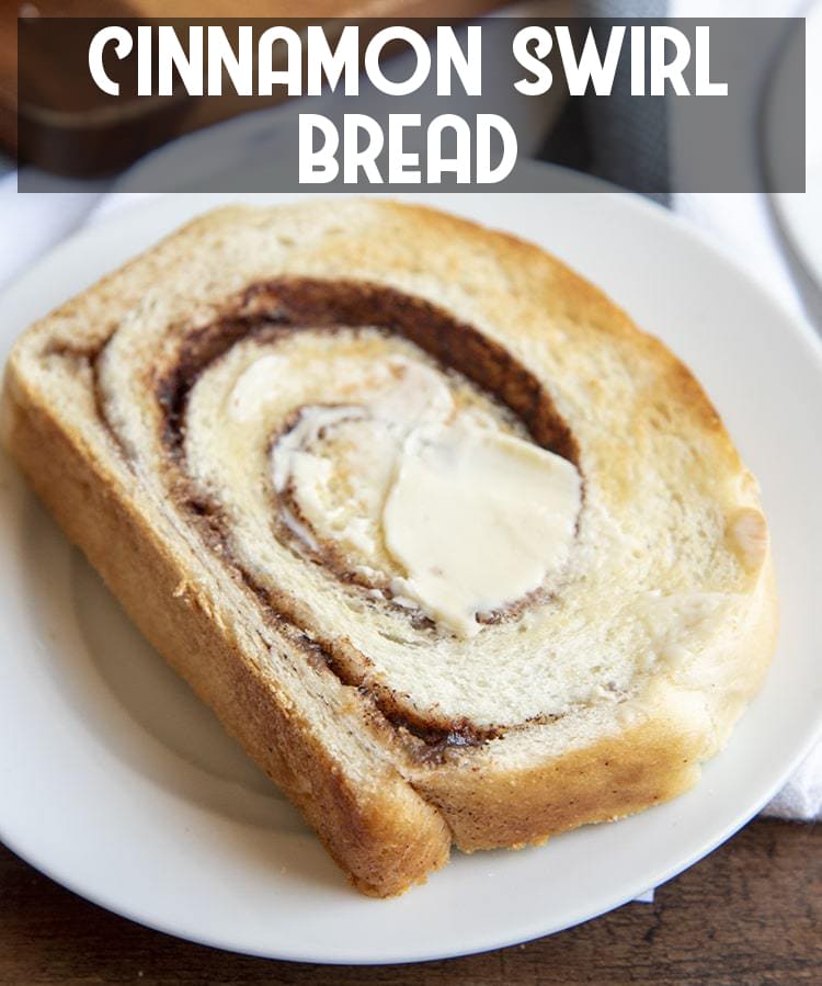 A piece of cinnamon swirl toast with butter on top on a white plate with text overlay for pinterest