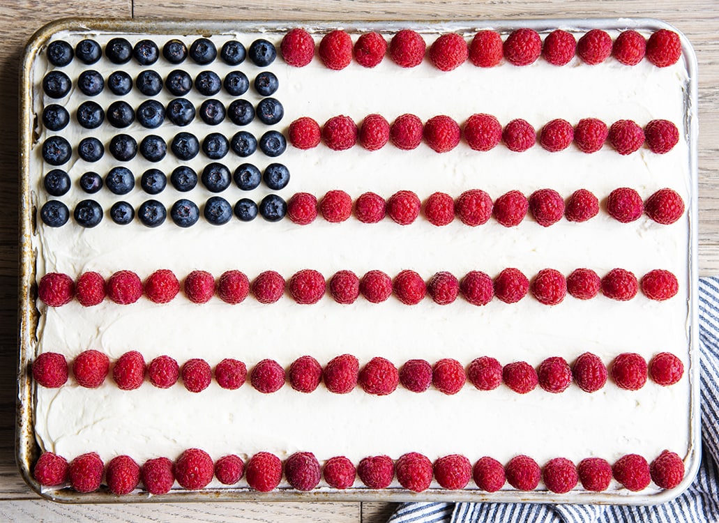 An American flag cake decorated with blueberries and raspberries to make an American flag