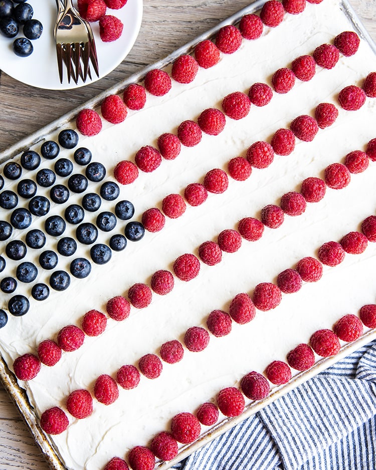 An American flag cake decorated with blueberries and raspberries